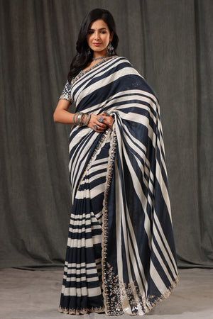 Buy stunning black and white stripes crepe georgette sari online in USA with saree blouse. Look classy at weddings and special occasions in exquisite designer sarees, embroidered sarees, party sarees, handwoven saris, pure silk sarees, Banarasi sarees, Kanjivaram sarees from Pure Elegance Indian saree store in USA.-front