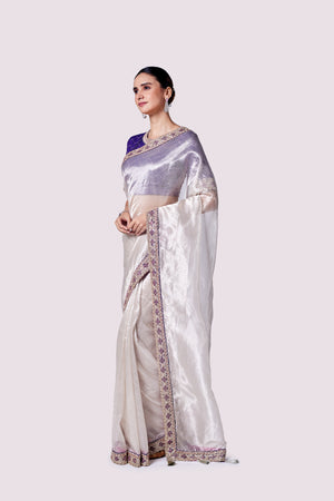 Buy silver zari tissue saree online in USA with purple embroidered designer blouse. Look like a royalty in exquisite designer sarees, embroidered sarees, handwoven sarees, pure silk saris, Banarasi sarees, Kanjivaram sarees from Pure Elegance Indian saree store in USA.-side