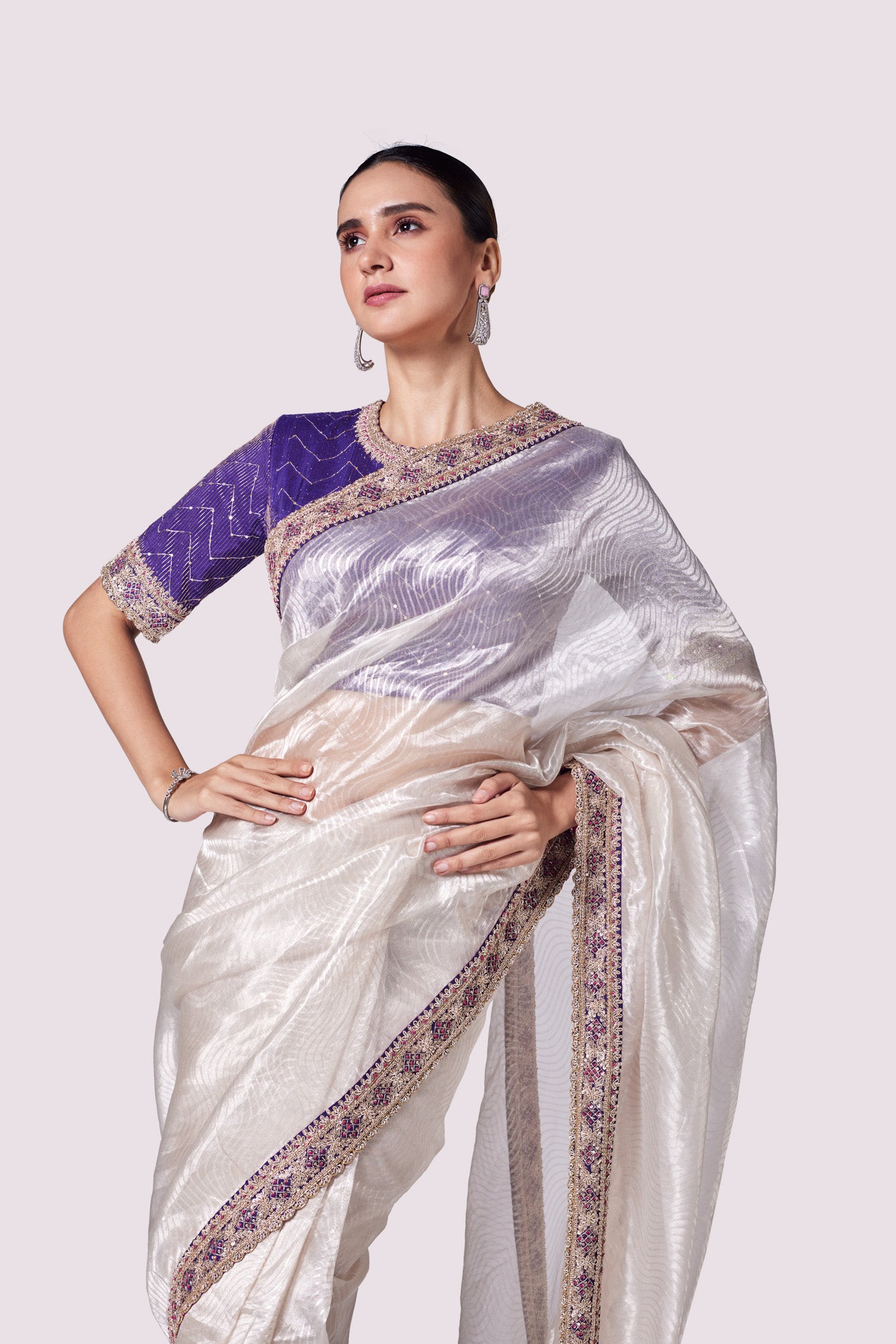 Buy silver zari tissue saree online in USA with purple embroidered designer blouse. Look like a royalty in exquisite designer sarees, embroidered sarees, handwoven sarees, pure silk saris, Banarasi sarees, Kanjivaram sarees from Pure Elegance Indian saree store in USA.-closuep