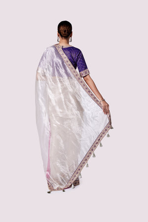 Buy silver zari tissue saree online in USA with purple embroidered designer blouse. Look like a royalty in exquisite designer sarees, embroidered sarees, handwoven sarees, pure silk saris, Banarasi sarees, Kanjivaram sarees from Pure Elegance Indian saree store in USA.-back