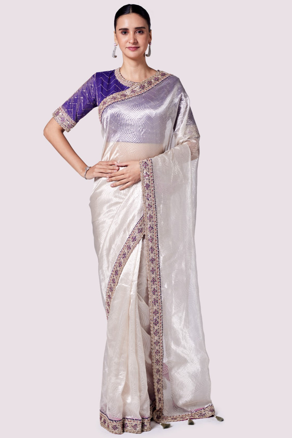 Buy silver zari tissue saree online in USA with purple embroidered designer blouse. Look like a royalty in exquisite designer sarees, embroidered sarees, handwoven sarees, pure silk saris, Banarasi sarees, Kanjivaram sarees from Pure Elegance Indian saree store in USA.-full view