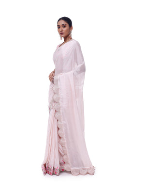 Buy powder pink chiffon saree online in USA with scalloped border and embroidered blouse. Look like a royalty in exquisite designer sarees, embroidered sarees, handwoven sarees, pure silk saris, Banarasi sarees, Kanjivaram sarees from Pure Elegance Indian saree store in USA.-pallu