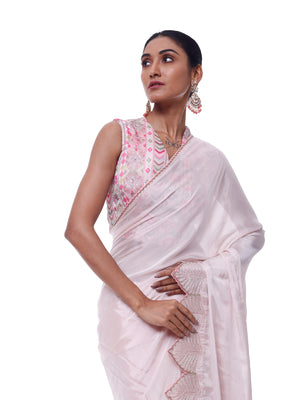 Buy powder pink chiffon saree online in USA with scalloped border and embroidered blouse. Look like a royalty in exquisite designer sarees, embroidered sarees, handwoven sarees, pure silk saris, Banarasi sarees, Kanjivaram sarees from Pure Elegance Indian saree store in USA.-closeup