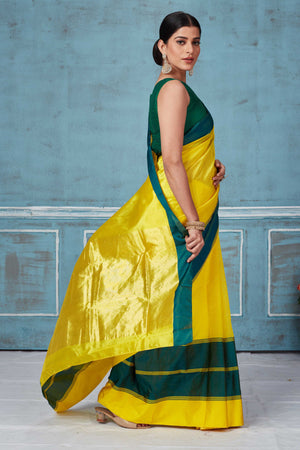 Buy yellow Pattu silk saree online in USA with green Mashru border. Look your best on festive occasions in latest designer saris, pure silk saris, Kanchipuram silk sarees, handwoven sarees, tussar silk sarees, embroidered sarees from Pure Elegance Indian fashion store in USA.-side