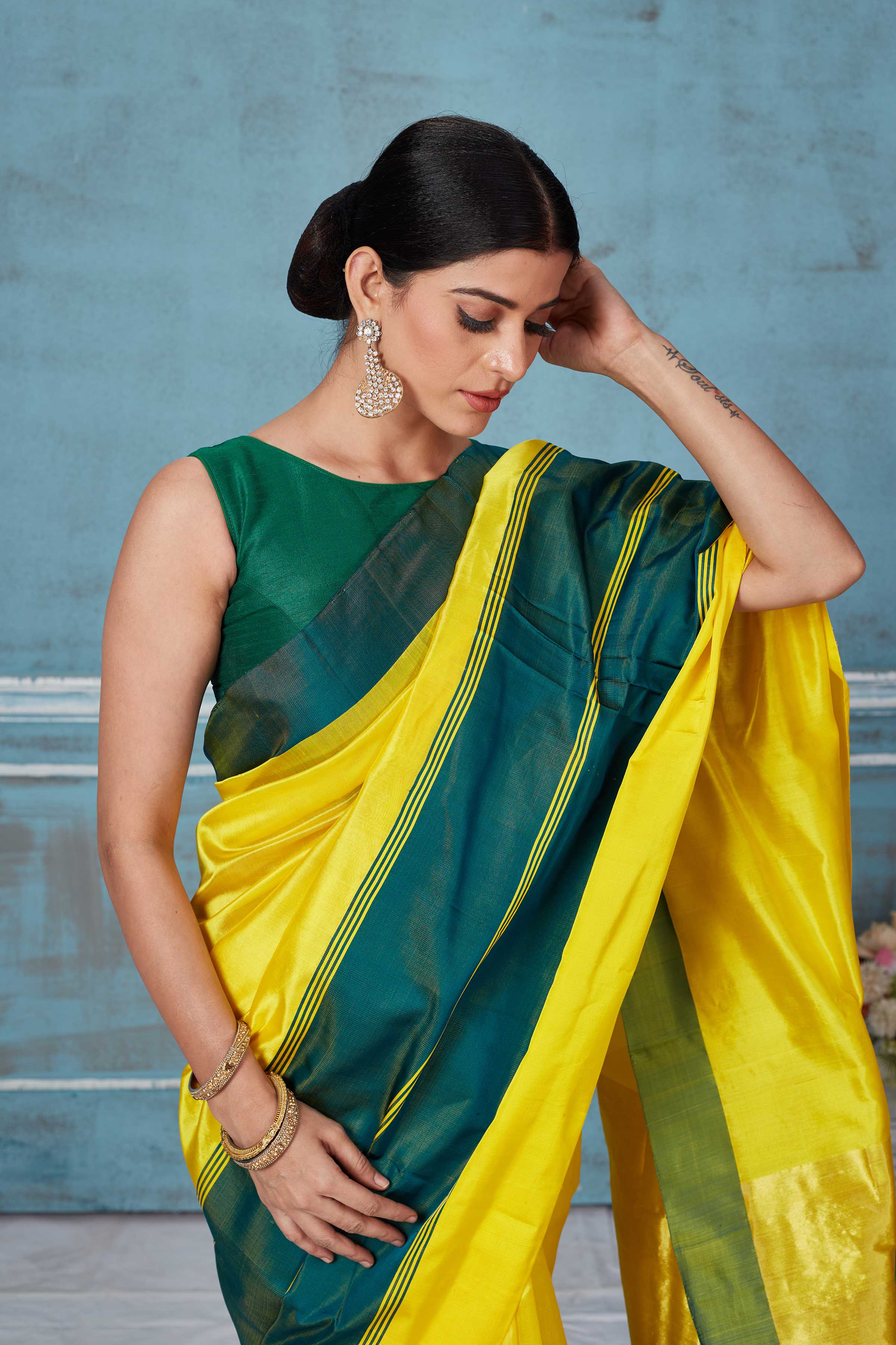 Buy yellow Pattu silk saree online in USA with green Mashru border. Look your best on festive occasions in latest designer saris, pure silk saris, Kanchipuram silk sarees, handwoven sarees, tussar silk sarees, embroidered sarees from Pure Elegance Indian fashion store in USA.-closeup