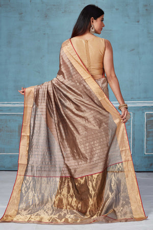 Shop beige striped Pattu silk saree online in USA with zari border. Look your best on festive occasions in latest designer saris, pure silk saris, Kanchipuram silk sarees, handwoven sarees, tussar silk sarees, embroidered sarees from Pure Elegance Indian fashion store in USA.-back