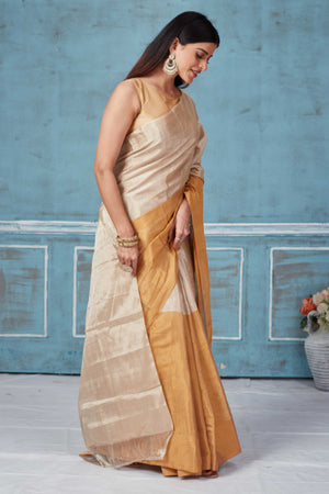 Shop beige golden tissue silk golden zari sari online in USA. Look your best on festive occasions in latest designer saris, pure silk saris, Kanchipuram silk sarees, handwoven sarees, tussar silk sarees, embroidered sarees from Pure Elegance Indian fashion store in USA.-side