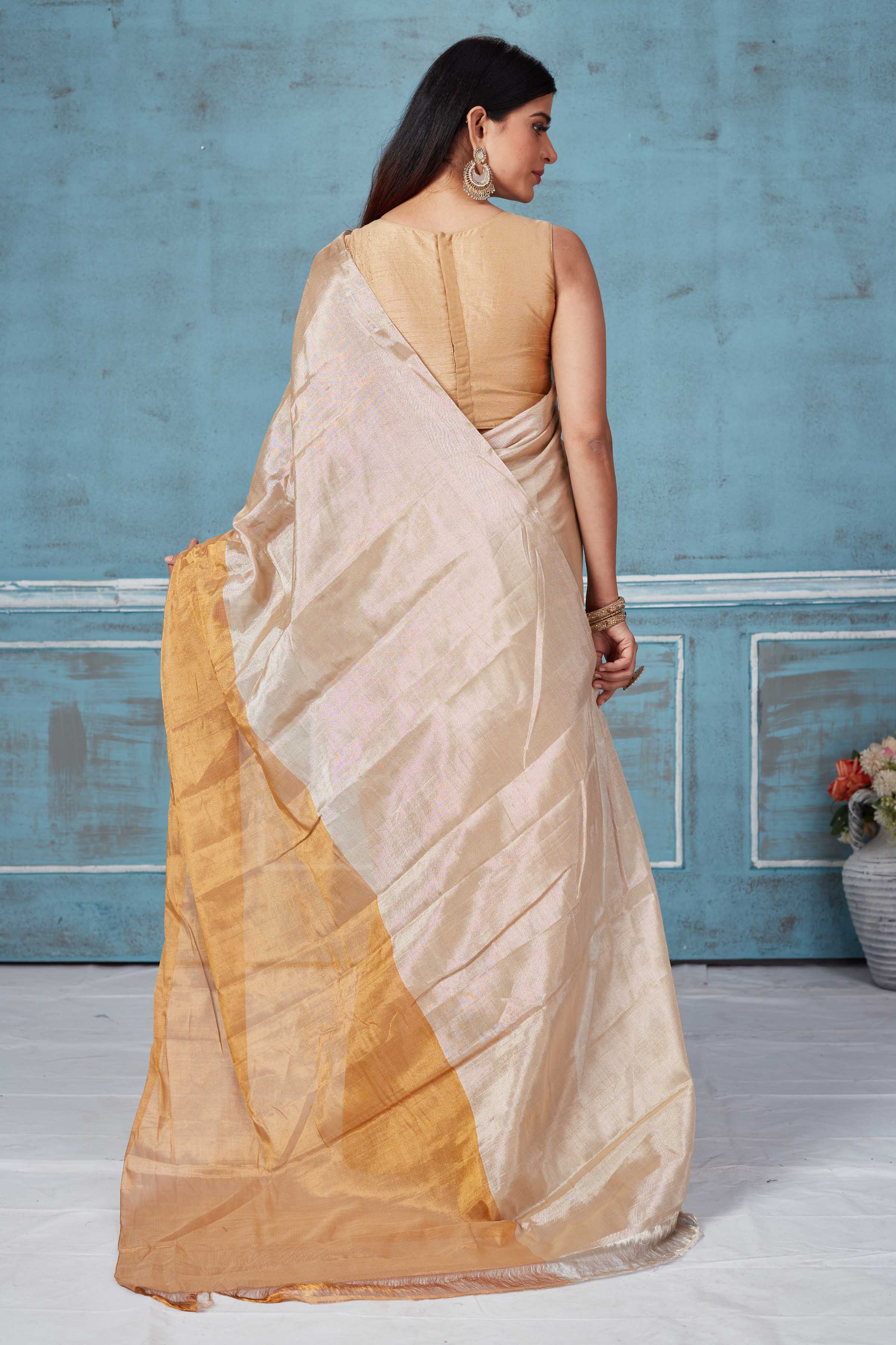 Shop beige golden tissue silk golden zari sari online in USA. Look your best on festive occasions in latest designer saris, pure silk saris, Kanchipuram silk sarees, handwoven sarees, tussar silk sarees, embroidered sarees from Pure Elegance Indian fashion store in USA.-back