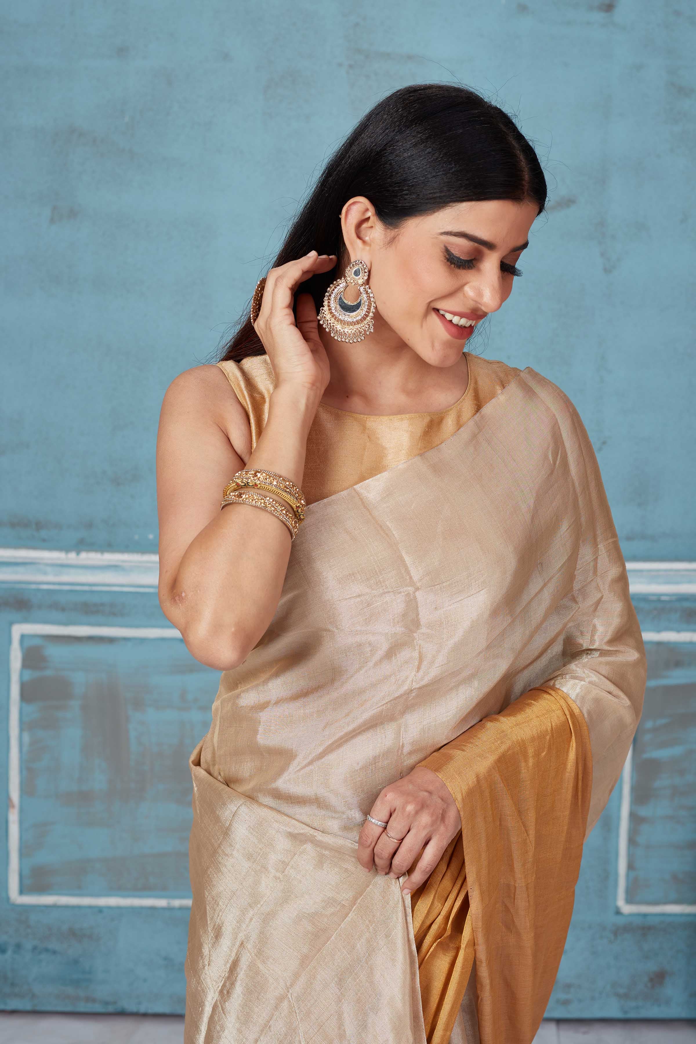 Shop beige golden tissue silk golden zari sari online in USA. Look your best on festive occasions in latest designer saris, pure silk saris, Kanchipuram silk sarees, handwoven sarees, tussar silk sarees, embroidered sarees from Pure Elegance Indian fashion store in USA.-closeup