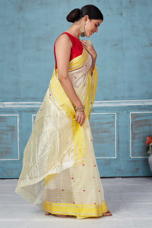 Shop beautiful cream Pattu silk sari online in USA with yellow border. Look your best on festive occasions in latest designer saris, pure silk saris, Kanchipuram silk sarees, handwoven sarees, tussar silk sarees, embroidered sarees from Pure Elegance Indian fashion store in USA.-side