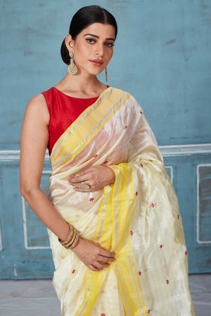 Shop beautiful cream Pattu silk sari online in USA with yellow border. Look your best on festive occasions in latest designer saris, pure silk saris, Kanchipuram silk sarees, handwoven sarees, tussar silk sarees, embroidered sarees from Pure Elegance Indian fashion store in USA.-closeup