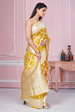 Shop beautiful yellow and orange Banarasi saree online in USA with zari jaal. Look your best on festive occasions in latest designer saris, pure silk sarees, Kanjivaram silk sarees, handwoven saris, tussar silk sarees, embroidered saris from Pure Elegance Indian fashion store in USA.-side