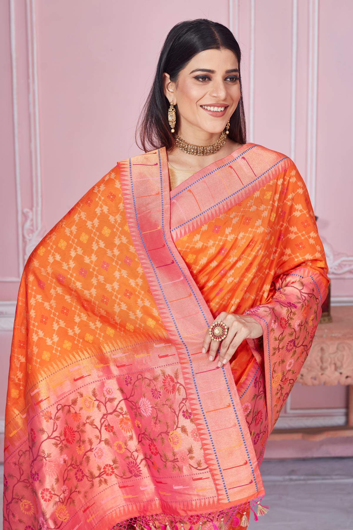 Shop orange Banarasi saree online in USA with heavy zari minakari border. Look your best on festive occasions in latest designer saris, pure silk sarees, Kanjivaram silk sarees, handwoven saris, tussar silk sarees, embroidered saris from Pure Elegance Indian fashion store in USA.-closeup