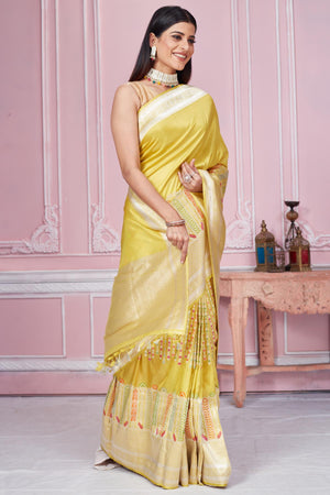 Buy stunning yellow Banarasi sari online in USA with zari minakari border. Look your best on festive occasions in latest designer saris, pure silk sarees, Kanjivaram silk sarees, handwoven saris, tussar silk sarees, embroidered saris from Pure Elegance Indian fashion store in USA.-side