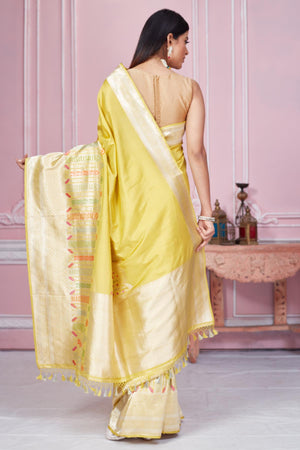 Buy stunning yellow Banarasi sari online in USA with zari minakari border. Look your best on festive occasions in latest designer saris, pure silk sarees, Kanjivaram silk sarees, handwoven saris, tussar silk sarees, embroidered saris from Pure Elegance Indian fashion store in USA.-back