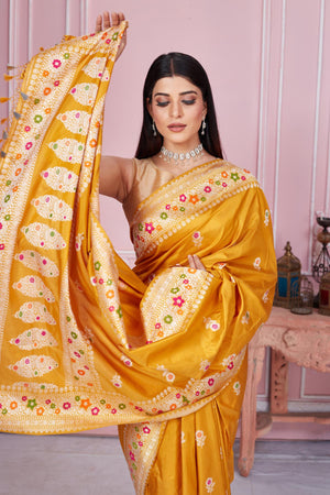 Shop beautiful mustard Banarasi sari online in USA with zari minakari border. Look your best on festive occasions in latest designer saris, pure silk sarees, Kanjivaram silk sarees, handwoven saris, tussar silk sarees, embroidered saris from Pure Elegance Indian fashion store in USA.-closeup