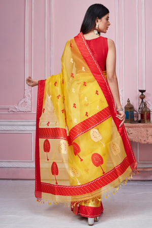 Shop yellow Banarasi sari online in USA with scattered red buti. Look your best on festive occasions in latest designer saris, pure silk sarees, Kanjivaram silk sarees, handwoven saris, tussar silk sarees, embroidered saris from Pure Elegance Indian fashion store in USA.-back