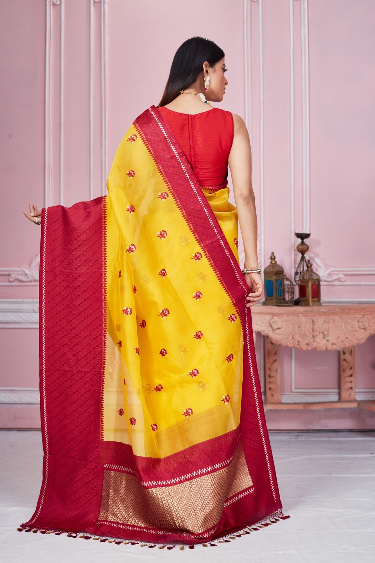 Buy yellow Banarasi saree online in USA with red border and zari pallu. Look your best on festive occasions in latest designer saris, pure silk sarees, Kanjivaram silk sarees, handwoven saris, tussar silk sarees, embroidered saris from Pure Elegance Indian fashion store in USA.-back