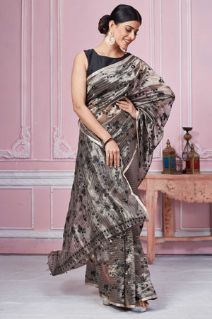Shop stunning metallic grey floral Banarasi saree online in USA. Look your best on festive occasions in latest designer sarees, pure silk saris, Kanchipuram silk sarees, handwoven sarees, tussar silk saris, embroidered sarees from Pure Elegance Indian fashion store in USA.-front