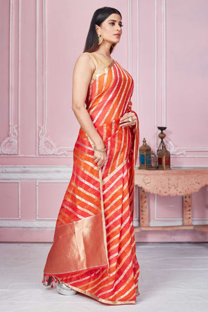 Shop red orange zari stripes Banarasi saree online in USA. Look your best on festive occasions in latest designer sarees, pure silk saris, Kanchipuram silk sarees, handwoven sarees, tussar silk saris, embroidered sarees from Pure Elegance Indian fashion store in USA.-side