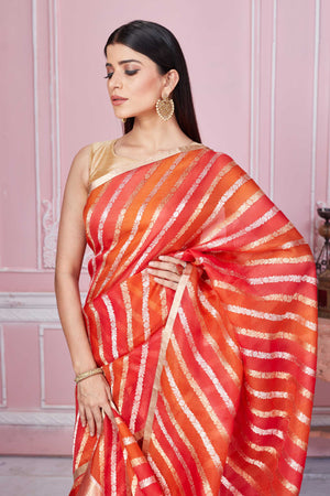 Shop red orange zari stripes Banarasi saree online in USA. Look your best on festive occasions in latest designer sarees, pure silk saris, Kanchipuram silk sarees, handwoven sarees, tussar silk saris, embroidered sarees from Pure Elegance Indian fashion store in USA.-closeup