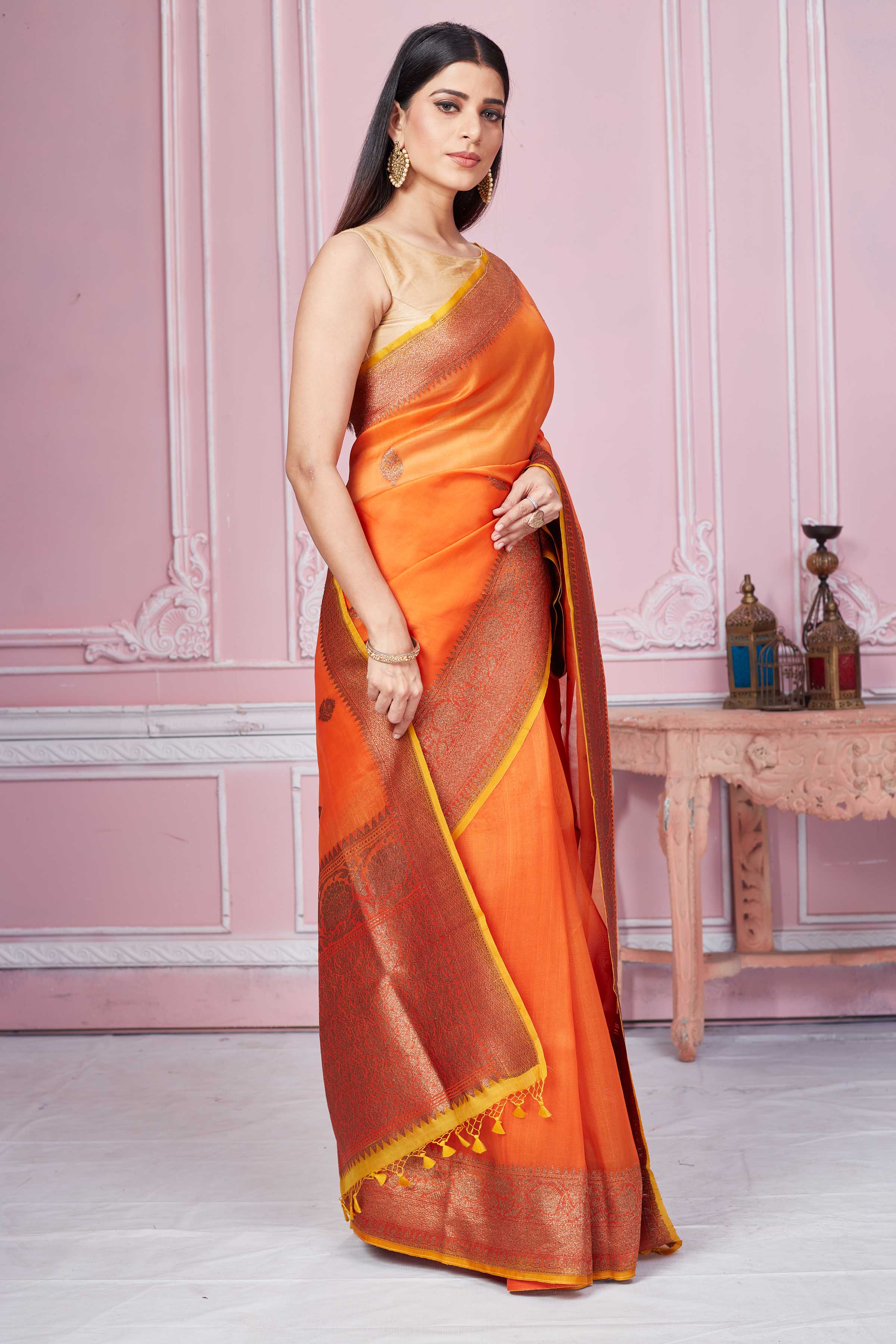Shop orange Banarasi saree online in USA with red zari border. Look your best on festive occasions in latest designer sarees, pure silk saris, Kanchipuram silk sarees, handwoven sarees, tussar silk saris, embroidered sarees from Pure Elegance Indian fashion store in USA.-side