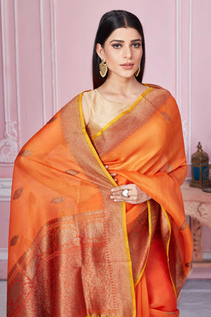 Shop orange Banarasi saree online in USA with red zari border. Look your best on festive occasions in latest designer sarees, pure silk saris, Kanchipuram silk sarees, handwoven sarees, tussar silk saris, embroidered sarees from Pure Elegance Indian fashion store in USA.-closeup
