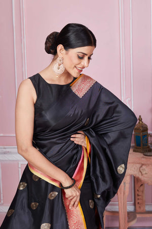 Shop black Banarasi sari online in USA with pink zari border. Look your best on festive occasions in latest designer sarees, pure silk saris, Kanchipuram silk sarees, handwoven sarees, tussar silk saris, embroidered sarees from Pure Elegance Indian fashion store in USA.-closeup