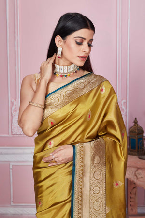 Buy golden Banarasi sari online in USA with zari minakari buta. Look your best on festive occasions in latest designer sarees, pure silk saris, Kanchipuram silk sarees, handwoven sarees, tussar silk saris, embroidered sarees from Pure Elegance Indian fashion store in USA.-closeup