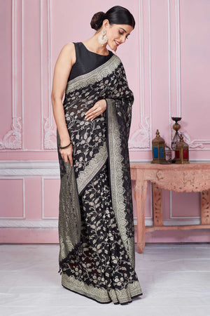 Shop black Banarasi sari online in USA with floral zari jaal. Look your best on festive occasions in latest designer sarees, pure silk saris, Kanchipuram silk sarees, handwoven sarees, tussar silk saris, embroidered sarees from Pure Elegance Indian fashion store in USA.-side
