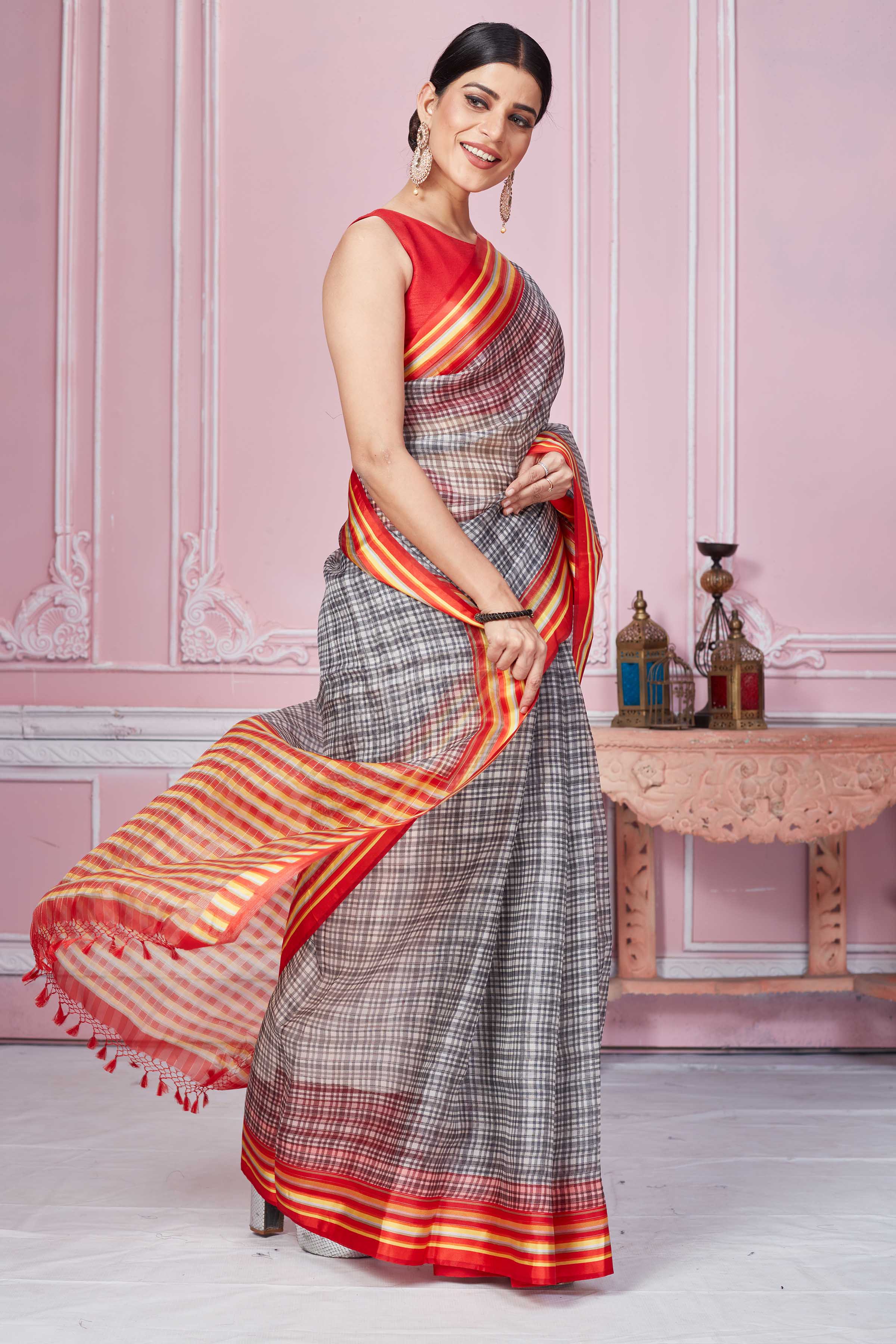 Buy grey check organza sari online in USA with red striped border. Look your best on festive occasions in latest designer sarees, pure silk saris, Kanchipuram silk sarees, handwoven sarees, tussar silk saris, embroidered sarees from Pure Elegance Indian fashion store in USA.-side