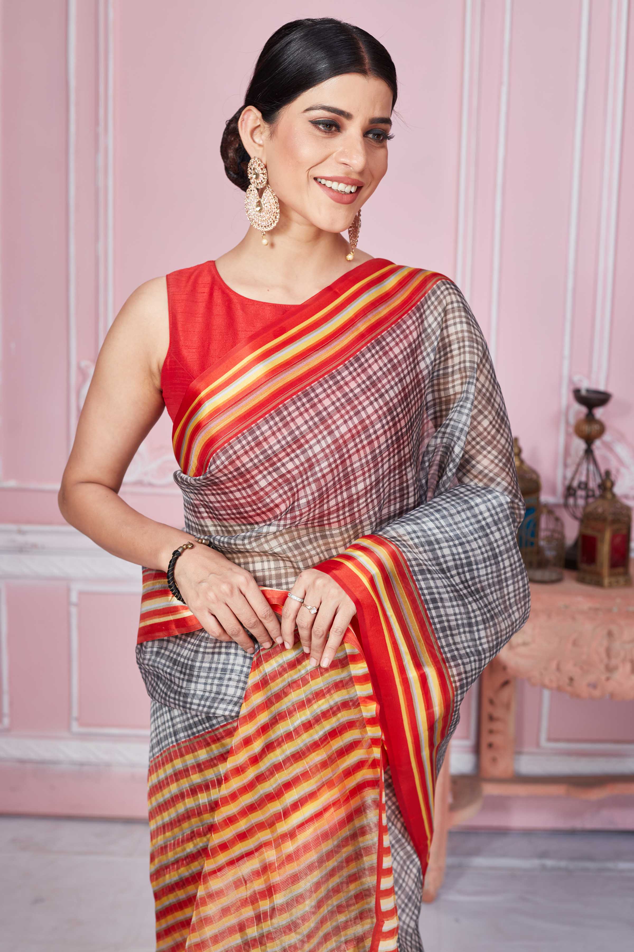 Buy grey check organza sari online in USA with red striped border. Look your best on festive occasions in latest designer sarees, pure silk saris, Kanchipuram silk sarees, handwoven sarees, tussar silk saris, embroidered sarees from Pure Elegance Indian fashion store in USA.-closeup