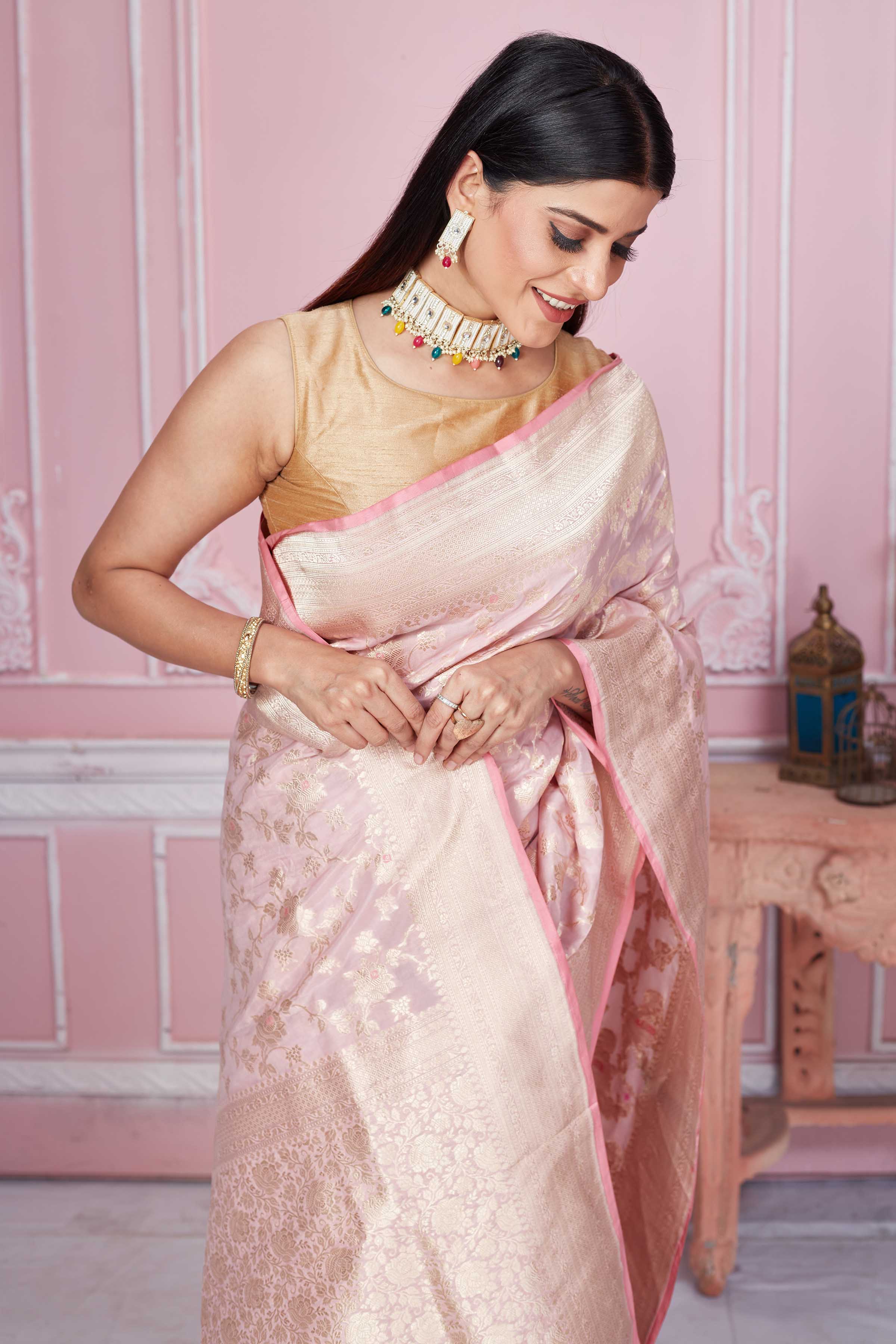 Shop powder pink Banarasi sari online in USA with floral zari jaal. Look your best on festive occasions in latest designer sarees, pure silk saris, Kanchipuram silk sarees, handwoven sarees, tussar silk saris, embroidered sarees from Pure Elegance Indian fashion store in USA.-closeup