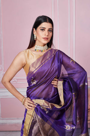 Buy purple Banarasi sari online in USA with golden zari border and zari motifs. Look your best on festive occasions in latest designer sarees, pure silk saris, Kanchipuram silk sarees, handwoven sarees, tussar silk saris, embroidered sarees from Pure Elegance Indian fashion store in USA.-closeup
