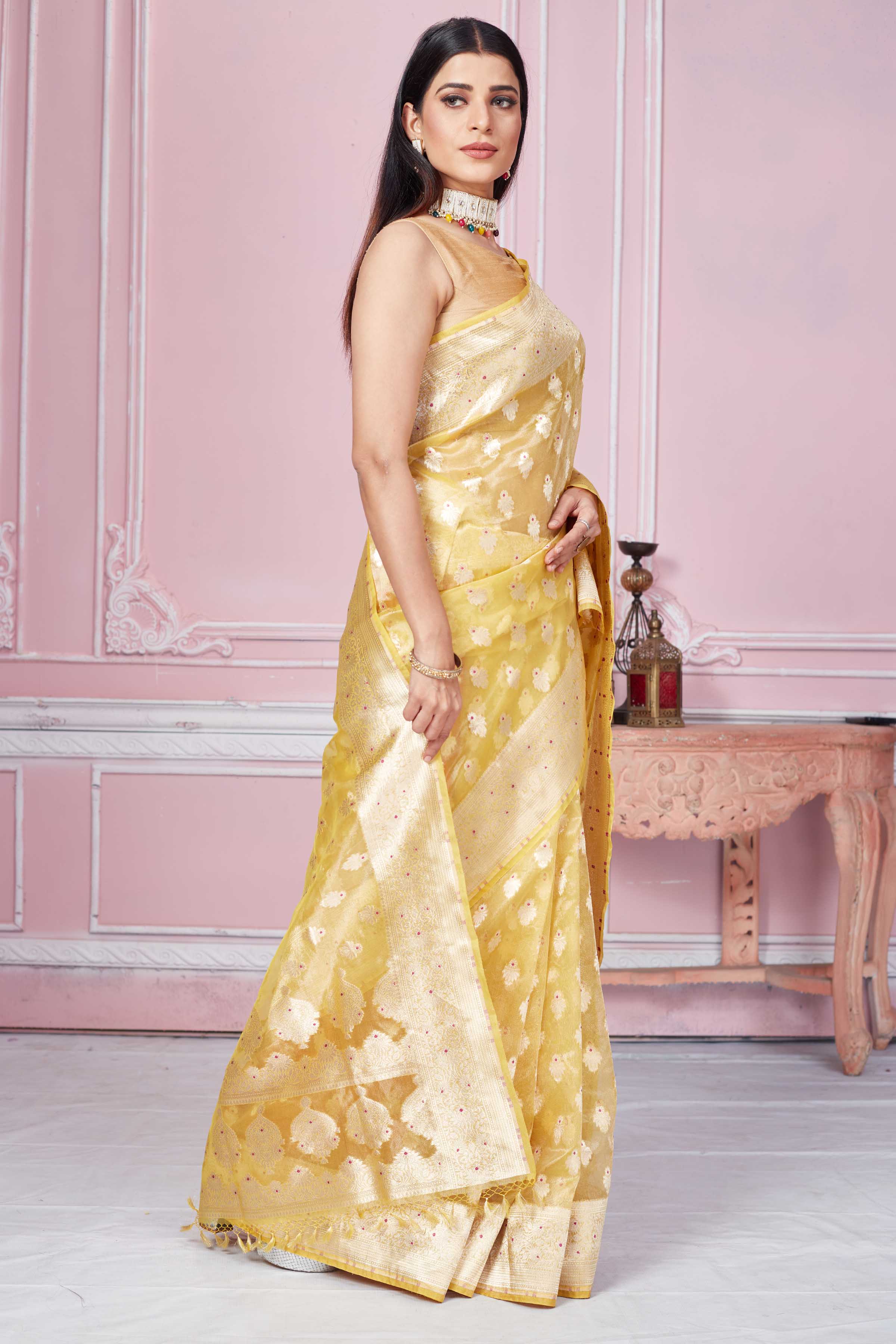Shop yellow Banarasi sari online in USA with zari minakari buta. Look your best on festive occasions in latest designer sarees, pure silk saris, Kanchipuram silk sarees, handwoven sarees, tussar silk saris, embroidered sarees from Pure Elegance Indian fashion store in USA.-side