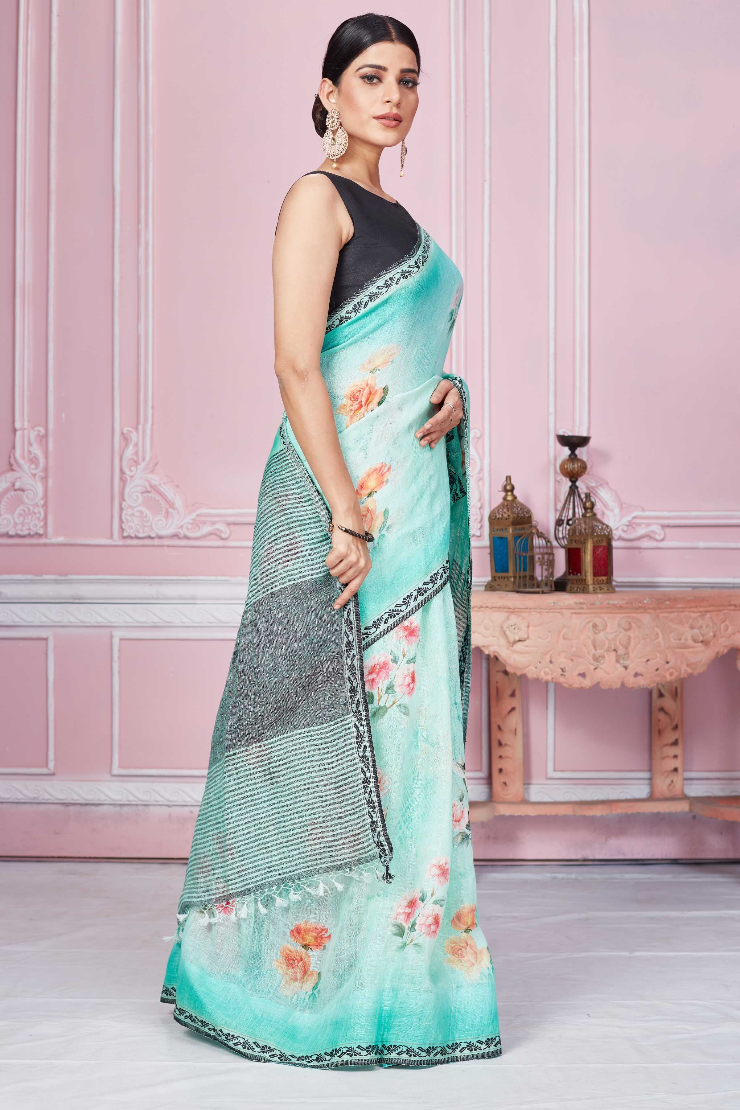 Shop pastel green floral print linen saree online in USA with striped pallu. Look your best on festive occasions in latest designer sarees, pure silk saris, Kanchipuram silk sarees, handwoven sarees, tussar silk saris, embroidered sarees from Pure Elegance Indian fashion store in USA.-side