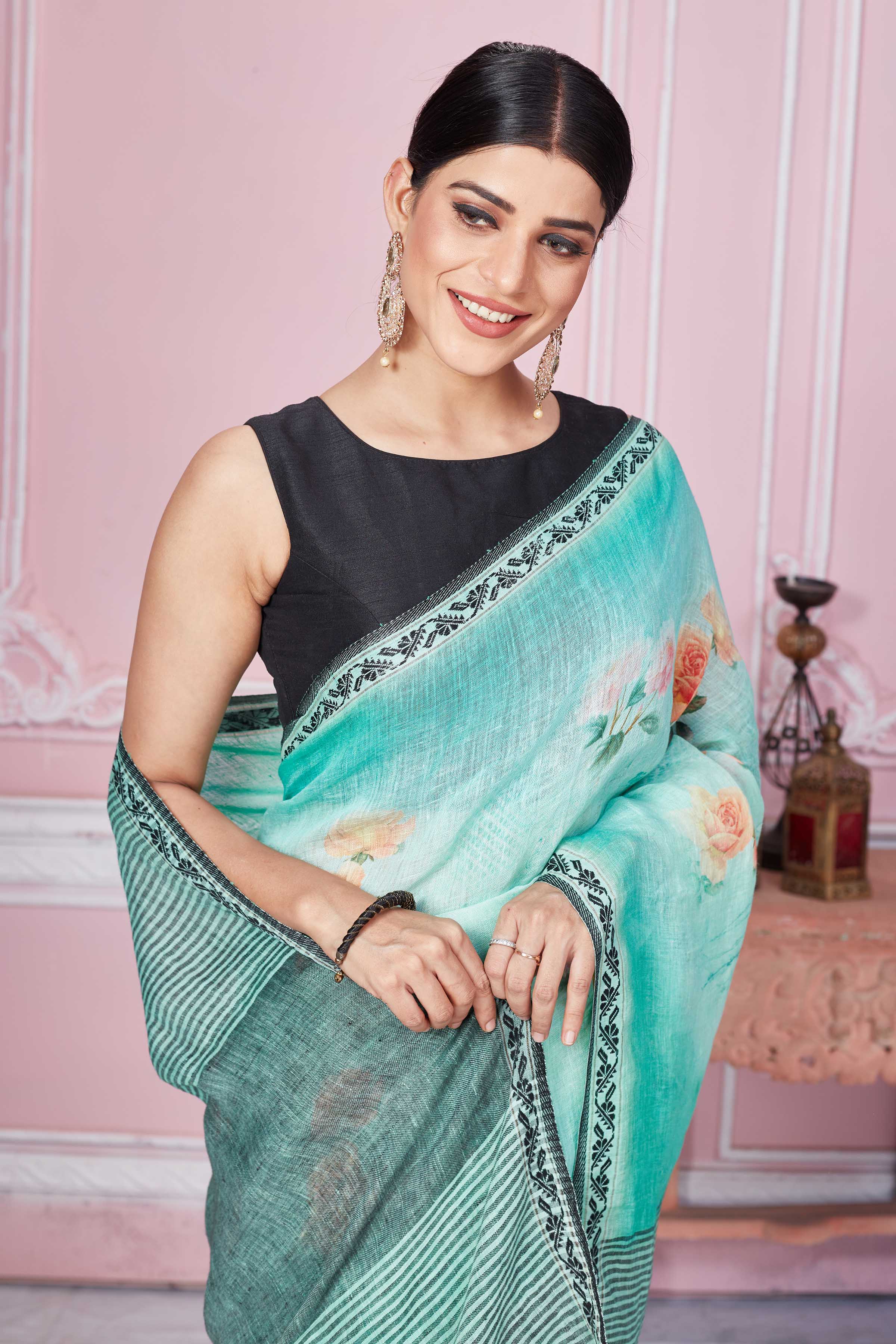 Shop pastel green floral print linen saree online in USA with striped pallu. Look your best on festive occasions in latest designer sarees, pure silk saris, Kanchipuram silk sarees, handwoven sarees, tussar silk saris, embroidered sarees from Pure Elegance Indian fashion store in USA.-closeup