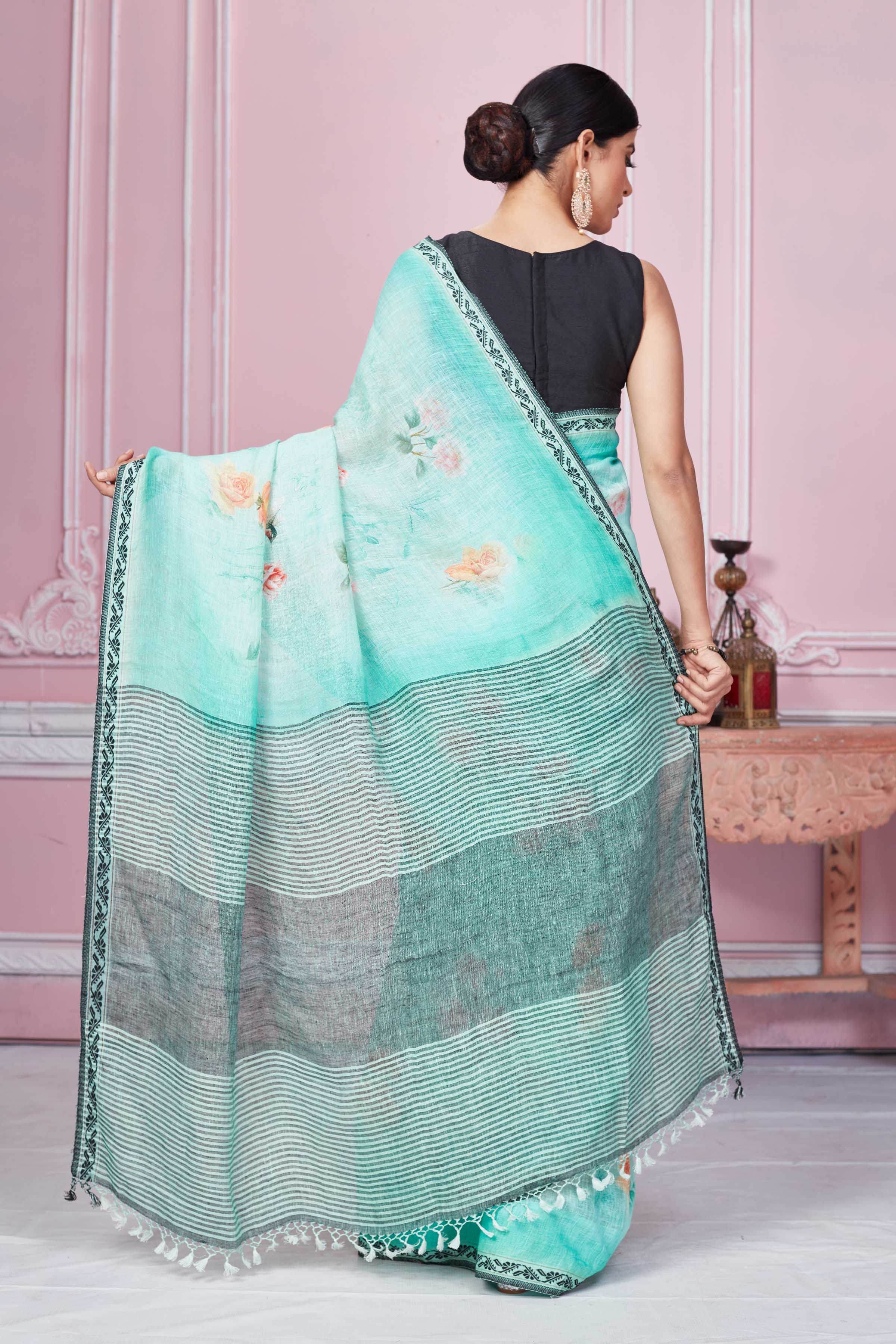 Shop pastel green floral print linen saree online in USA with striped pallu. Look your best on festive occasions in latest designer sarees, pure silk saris, Kanchipuram silk sarees, handwoven sarees, tussar silk saris, embroidered sarees from Pure Elegance Indian fashion store in USA.-back