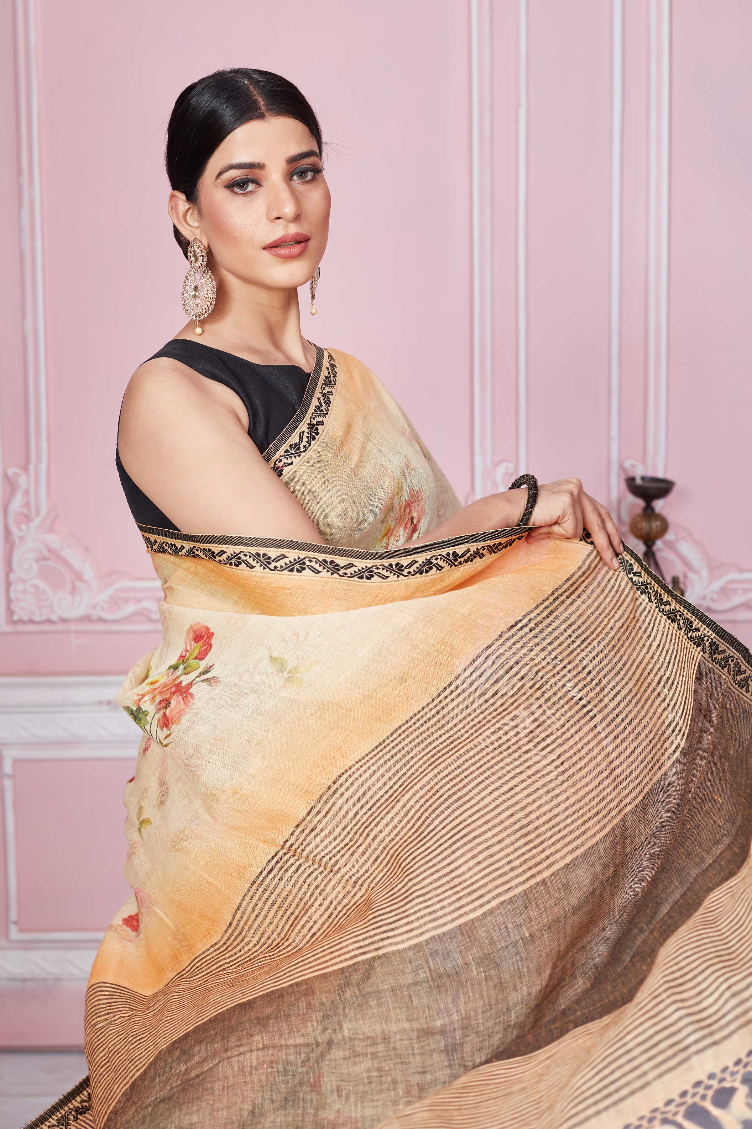 Buy peach floral print linen saree online in USA with striped pallu. Look your best on festive occasions in latest designer sarees, pure silk saris, Kanchipuram silk sarees, handwoven sarees, tussar silk saris, embroidered sarees from Pure Elegance Indian fashion store in USA.-closeup
