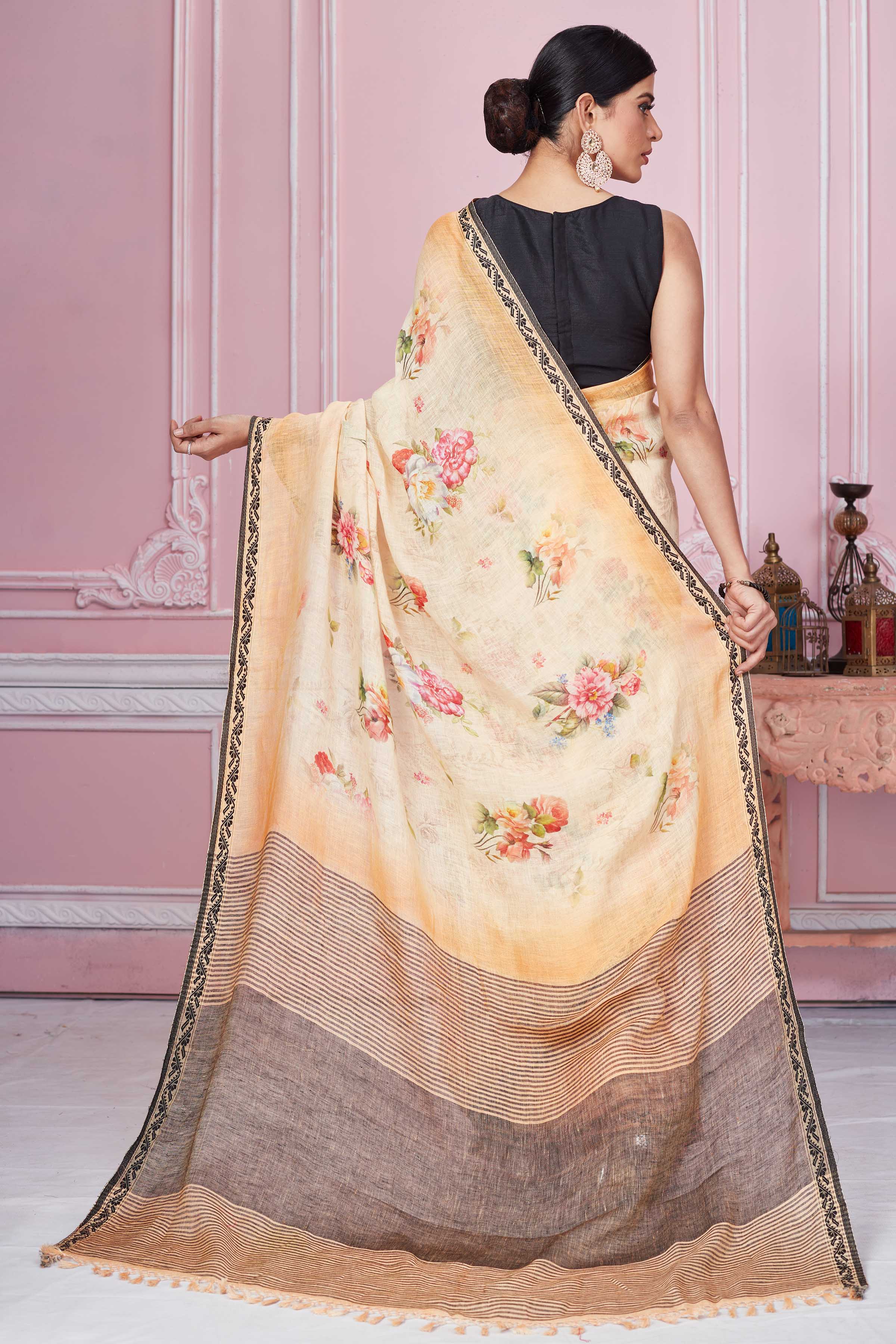 Buy peach floral print linen saree online in USA with striped pallu. Look your best on festive occasions in latest designer sarees, pure silk saris, Kanchipuram silk sarees, handwoven sarees, tussar silk saris, embroidered sarees from Pure Elegance Indian fashion store in USA.-back