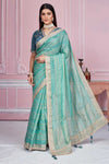 Shop sea green striped embroidered organza sari online in USA with blouse. Look your best on festive occasions in latest designer sarees, pure silk sarees, Kanjivaram silk saris, handwoven saris, tussar silk sarees, embroidered saris from Pure Elegance Indian clothing store in USA.-full view