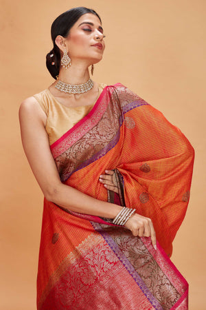 Buy orange tussar Banarasi sari online in USA with purple magenta zari border. Look your best on festive occasions in latest designer saris, pure silk sarees, Kanjivaram silk sarees, handwoven saris, tussar silk sarees, embroidered saris from Pure Elegance Indian clothing store in USA.-closeup
