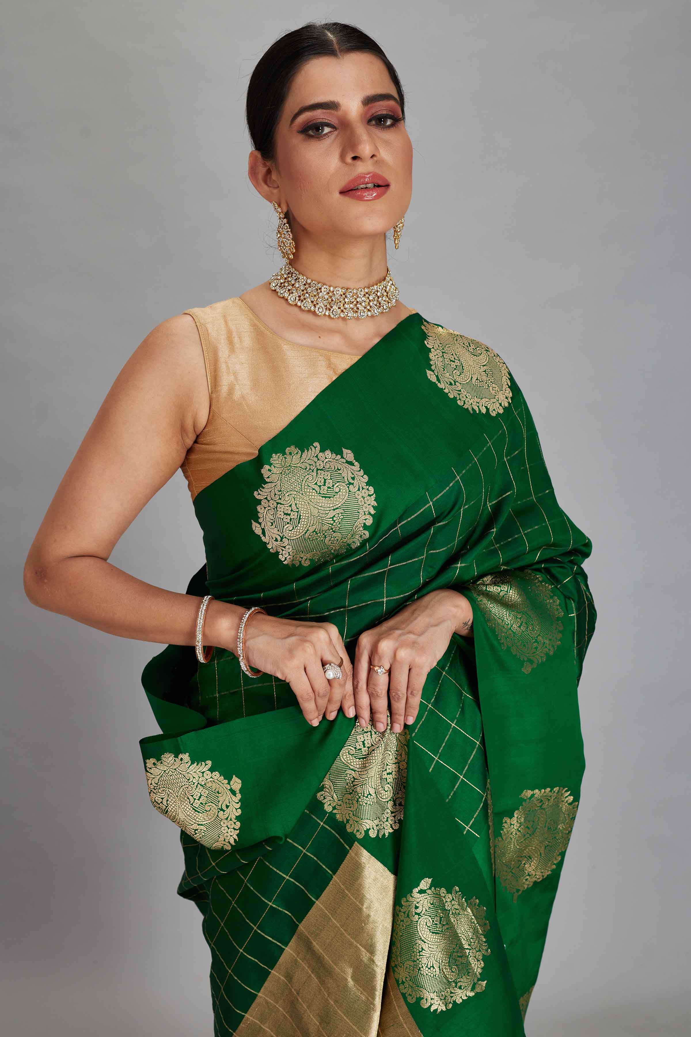 Shop bottle green check silk Banarasi sari online in USA with zari motifs border. Look your best on festive occasions in latest designer sarees, pure silk sarees, Kanjivaram silk saris, handwoven saris, tussar silk sarees, embroidered saris from Pure Elegance Indian clothing store in USA.-closeup