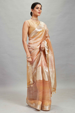 Shop peach and silver striped tissue Banarasi saree online in USA. Look your best on festive occasions in latest designer sarees, pure silk sarees, Kanjivaram silk saris, handwoven saris, tussar silk sarees, embroidered saris from Pure Elegance Indian clothing store in USA.-side