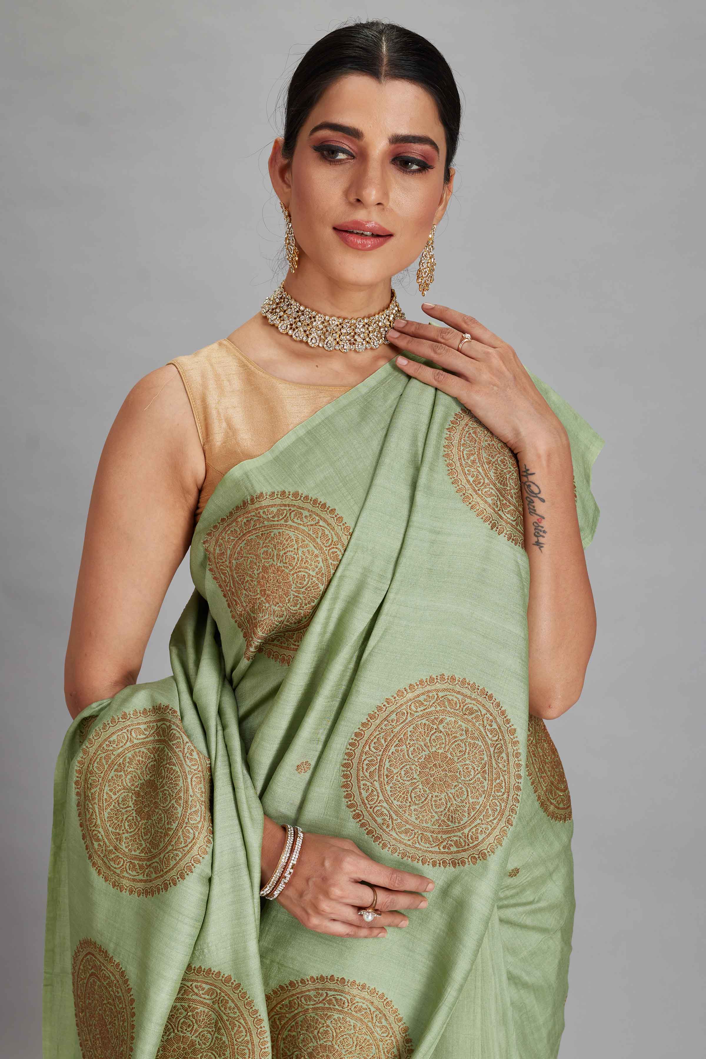 Buy sage green Muga silk Banarasi sari online in USA with big zari motifs. Look your best on festive occasions in latest designer sarees, pure silk sarees, Kanjivaram silk saris, handwoven saris, tussar silk sarees, embroidered saris from Pure Elegance Indian clothing store in USA.-closeup