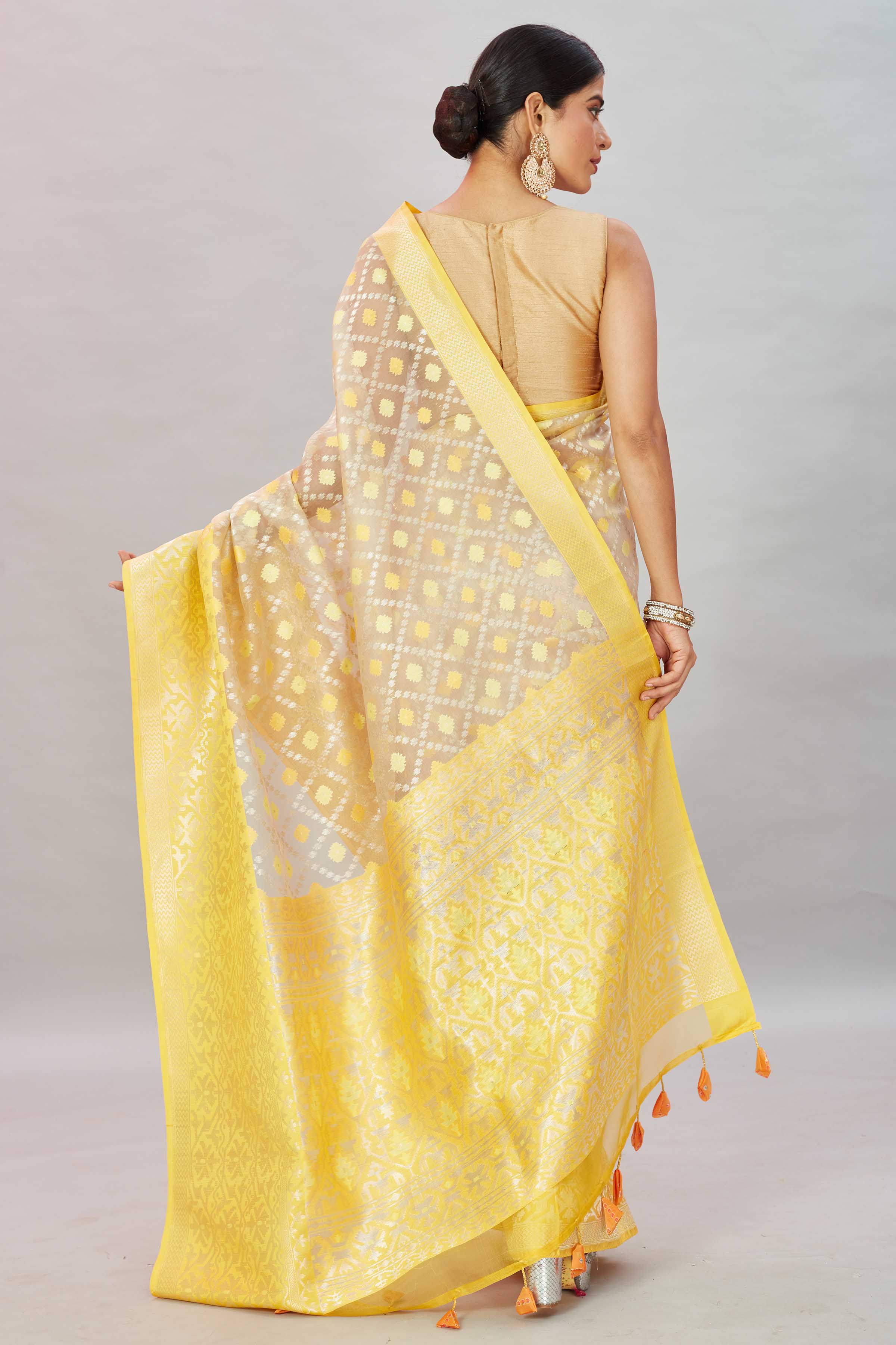 Shop cream Kora Banarasi sari online in USA with heavy yellow border. Look your best on festive occasions in latest designer sarees, pure silk sarees, Kanjivaram silk saris, handwoven saris, tussar silk sarees, embroidered saris from Pure Elegance Indian clothing store in USA.-back