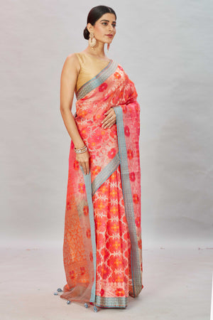 Shop pink and orange Kora Banarasi sari online in USA with blue border. Look your best on festive occasions in latest designer sarees, pure silk sarees, Kanjivaram silk saris, handwoven saris, tussar silk sarees, embroidered saris from Pure Elegance Indian clothing store in USA.-side