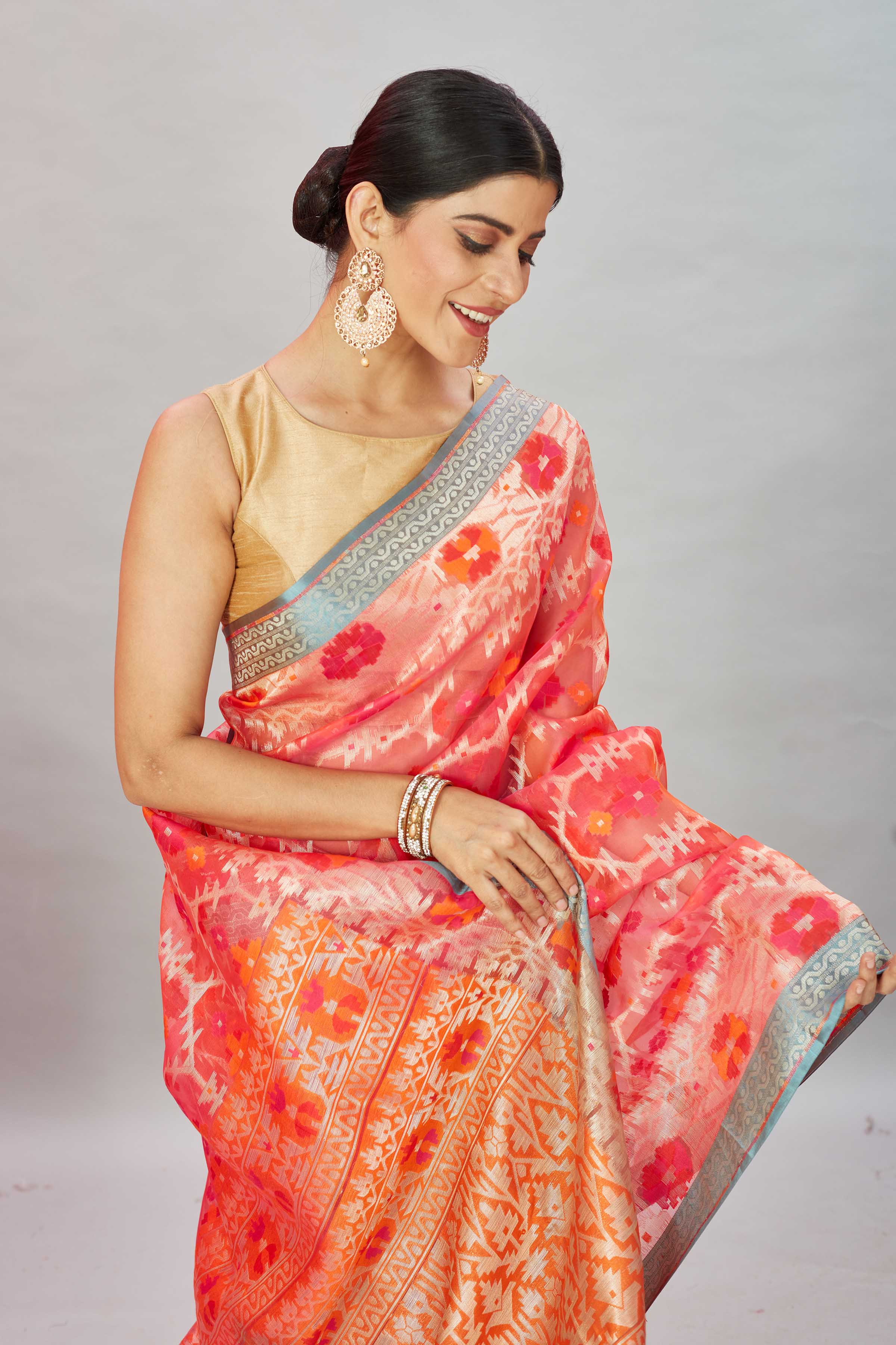 Shop pink and orange Kora Banarasi sari online in USA with blue border. Look your best on festive occasions in latest designer sarees, pure silk sarees, Kanjivaram silk saris, handwoven saris, tussar silk sarees, embroidered saris from Pure Elegance Indian clothing store in USA.-closeup