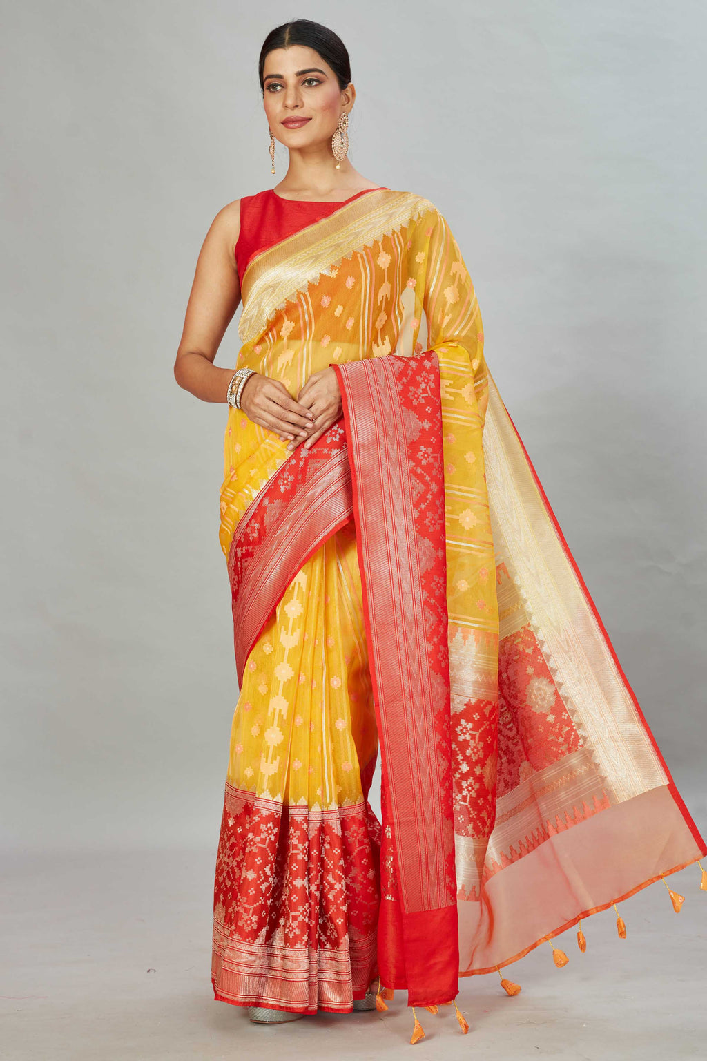 Buy yellow Kora Banarasi sari online in USA with red zari border. Look your best on festive occasions in latest designer sarees, pure silk sarees, Kanjivaram silk saris, handwoven saris, tussar silk sarees, embroidered saris from Pure Elegance Indian clothing store in USA.-full view
