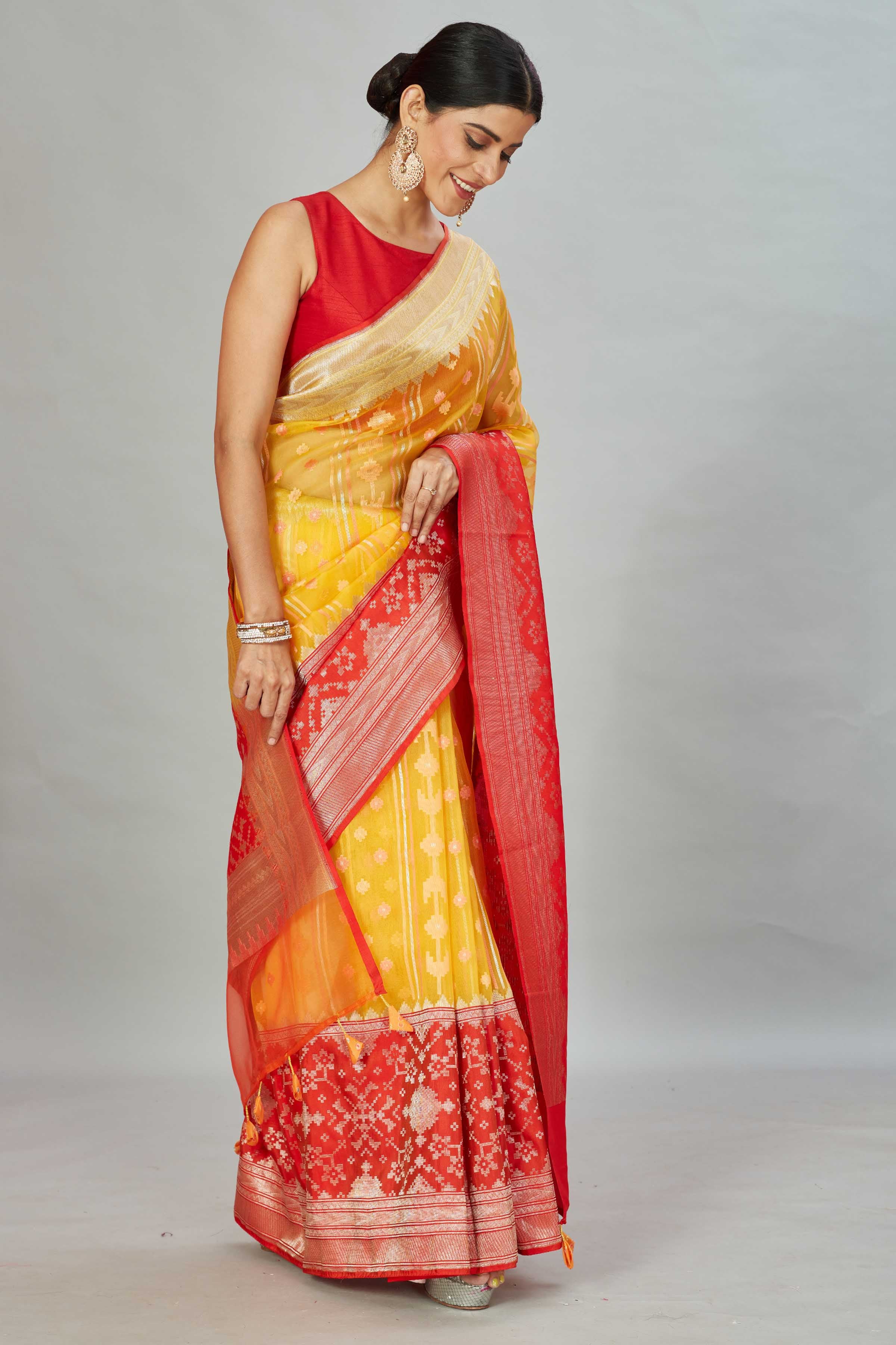 Buy yellow Kora Banarasi sari online in USA with red zari border. Look your best on festive occasions in latest designer sarees, pure silk sarees, Kanjivaram silk saris, handwoven saris, tussar silk sarees, embroidered saris from Pure Elegance Indian clothing store in USA.-side